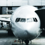 Air France Boeing 777 parked at an airport gate with the passenger boarding bridge still connected before pushback