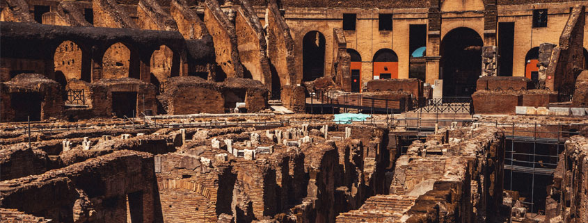 Ancient archaeological ruins outdoors featuring weathered stone structures and remnants of historic architecture