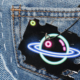 Blue denim jeans back pocket featuring a creative representation of the cosmos, symbolizing the universe within everyday reach
