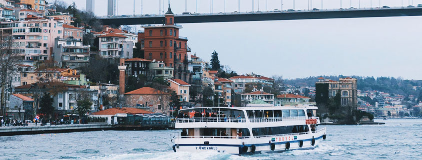 Bosphorus-Bridge-View-From-Boat-Tour-Istanbul-Turkey View of a suspension bridge spanning the Bosphorus Strait in Istanbul, Turkey, photographed during a boat tour