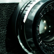 Camera lens with Canon and Bell and Howell branding visible on the equipment