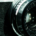 Camera lens with Canon and Bell and Howell branding visible on the equipment