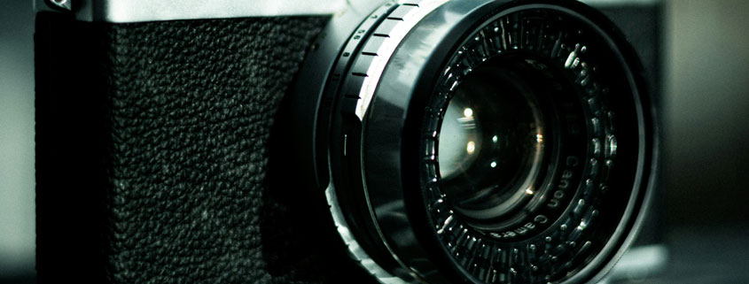 Canon-Bell-and-Howell-Camera-Lens-Close-Up Camera lens with Canon and Bell and Howell branding visible on the equipment