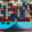 Large cargo ship loaded with stacked shipping containers traveling across the water