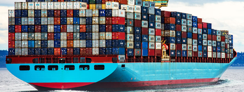 Cargo-Container-Ship-Transporting-Goods-Across-the-Water Large cargo ship loaded with stacked shipping containers traveling across the water