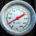 Analog temperature gauge mounted on black metal equipment with a Celsius scale ranging from 0 to 500 degrees
