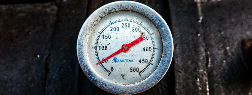 Analog temperature gauge mounted on black metal equipment with a Celsius scale ranging from 0 to 500 degrees