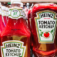 Multiple Heinz tomato ketchup bottles displaying their recognizable red ketchup and classic branded labels