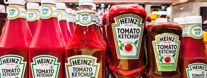 Multiple Heinz tomato ketchup bottles displaying their recognizable red ketchup and classic branded labels