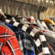 Colorful shirts neatly arranged on hangers along a clothing rack, displaying a variety of colors and styles in a retail fashion setting