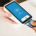 Customer inserting a payment card into a handheld card reader held by another person during a business transaction