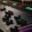DJ mixing console with brightly illuminated buttons and sound controls in a dark party environment