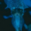 Squid swimming underwater in the deep ocean, surrounded by dark blue seawater