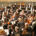 Musicians preparing for an orchestral performance before a large audience inside the Elbphilharmonie concert hall in Hamburg, Germany