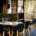 Elegant restaurant interior with clean, neatly arranged tables and chairs and employees working in the background