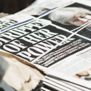 Bundles of freshly printed Evening Standard newspapers stacked on a London street, displaying headlines about political power struggles