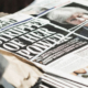 Bundles of freshly printed Evening Standard newspapers stacked on a London street, displaying headlines about political power struggles