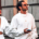 Stylish man and woman wearing coordinated all-white fashion outfits and sunglasses, with the man wearing oversized boots