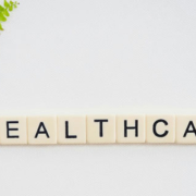 Healthcare sign positioned beside a curved green branch with fresh leaves