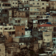 Cluster of houses built along a hillside, forming a compact residential community resembling a small town