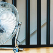 Large floor fan running in a clean and tidy indoor room to circulate air throughout the space