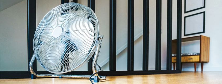 Large floor fan running in a clean and tidy indoor room to circulate air throughout the space