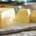 Large block of golden-yellow butter with two neatly cut slices showing its smooth texture and rich color
