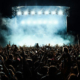 Group of performers gathered onstage during a live music concert or touring performance