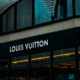 Exterior of a Louis Vuitton luxury retail building showing its distinctive architecture, brand signage, and main entrance