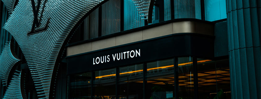 Louis-Vuitton-Luxury-Store-Building-and-Main-Entrance Exterior of a Louis Vuitton luxury retail building showing its distinctive architecture, brand signage, and main entrance