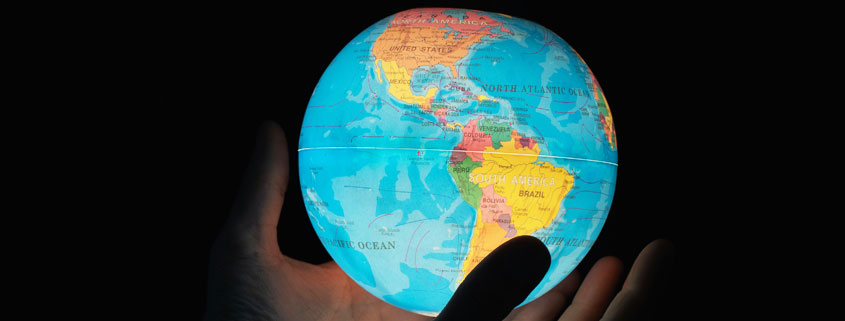 Man-Holding-Earth-Globe-With-North-and-South-America-Visible Man holding planet Earth in his hands with North America and South America facing forward