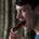 Man with his mouth open, preparing to bite into a sausage