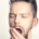Man holding his hand near his mouth while keeping his mouth open, appearing to breathe through his mouth