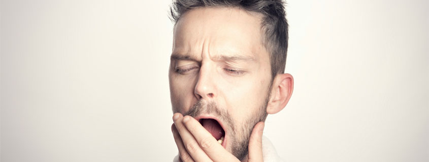 Man-With-Open-Mouth-Showing-Mouth-Breathing Man holding his hand near his mouth while keeping his mouth open, appearing to breathe through his mouth