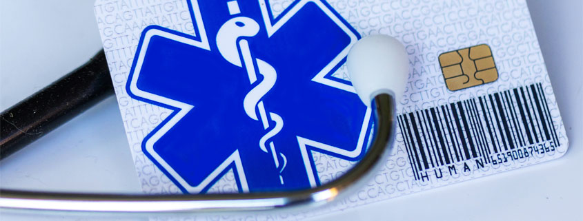 Medical stethoscope beside a Health Care card displaying a snake-entwined staff and cross symbol