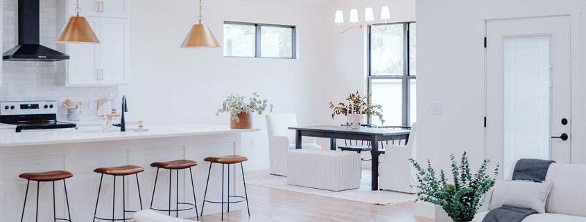 Modern-Open-Concept-Interior-With-Living-Room-Kitchen-and-Dining-Areas Modern open-concept home interior featuring a living room, multiple dining areas, and a kitchen with a bar counter in a connected residential layout