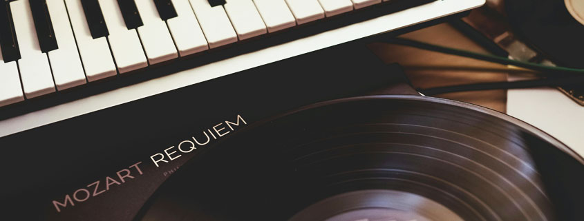 Mozart-Requiem-Vinyl-Record-Beside-Piano Mozart Requiem vinyl record displayed beside a piano, representing classical music and the emotional power of sound and silence