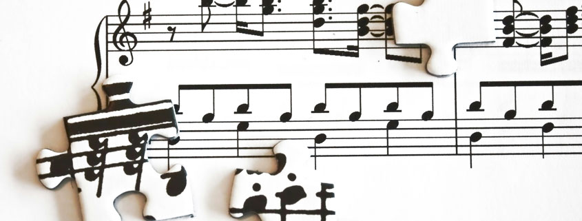 Musical notes and staff notation combined with interlocking puzzle pieces in a visual representation of music theory