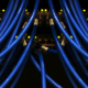 Numerous Ethernet network cables connected to rows of network equipment ports with illuminated LED status indicators