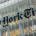 Exterior of The New York Times building at night, with illuminated windows and the newspaper's name visible on the facade