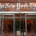 Main entrance to The New York Times building in New York City, featuring glass doors and The New York Times name displayed above the entrance