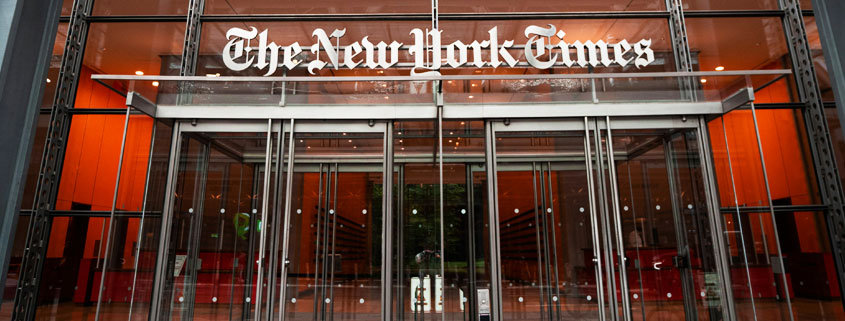 New-York-Times-Building-Main-Entrance-Glass-Doors Main entrance to The New York Times building in New York City, featuring glass doors and The New York Times name displayed above the entrance