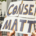 Hands holding a sign reading Consent Matters during a public protest rally