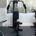 Compact home gym featuring an exercise machine and workout weights arranged in a small indoor fitness space