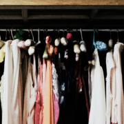 Wardrobe filled with vintage women's clothing and dresses hanging together in a collection of traditional fashion styles