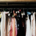Wardrobe filled with vintage women's clothing and dresses hanging together in a collection of traditional fashion styles