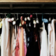 Wardrobe filled with vintage women's clothing and dresses hanging together in a collection of traditional fashion styles