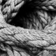 Thick rope gathered into a loose pile with overlapping loops and visible slack
