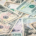 Scattered American five-dollar, ten-dollar, and twenty-dollar bills overlapping in a disorderly arrangement