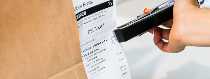 Uber-Eats-Delivery-Receipt-Attached-to-Food-Order-Bag Uber Eats delivery receipt attached to a food order bag for identification and delivery